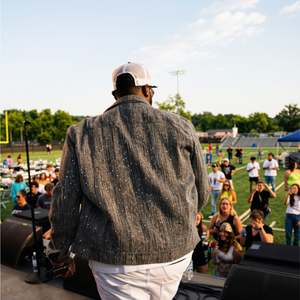 Stephen Thomas facing the crowd from the stage at the Woody Fest