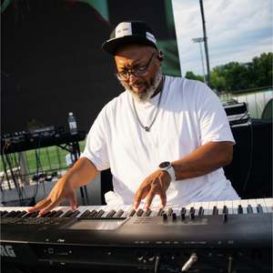 Stephen Thomas' keyboardist performing at the Woody Fest