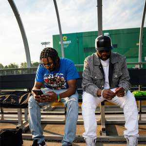 Stephen Thomas and a member of his team seated backstage at the Woody Fest